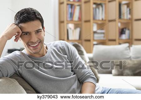 Man resting on a couch View Large Photo Image Stock Image - Man resting on a couch. Fotosearch