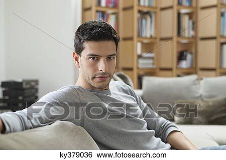 Man resting on a couch View Large Photo Image Stock Photograph - Man resting on a couch. Fotosearch