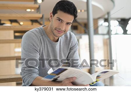 Man sitting on stairs and reading a magazine View Large Photo Image Stock Image - Man sitting on stairs and reading a magazine. Fotosearch