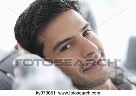 Portrait of a man resting on a couch View Large Photo Image Stock Image - Portrait of a man resting on a couch. Fotosearch