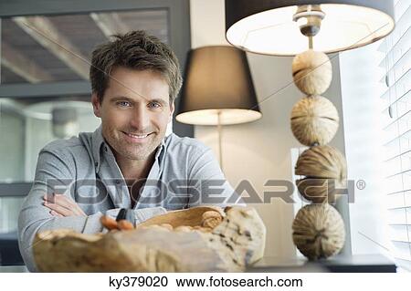 Portrait of a man smiling at home View Large Photo Image Stock Image - Portrait of a man smiling at home. Fotosearch