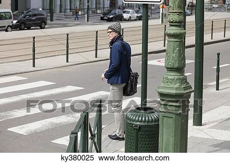 Businessman standing at the roadside View Large Photo Image Stock Photography - Businessman standing at the roadside. Fotosearch