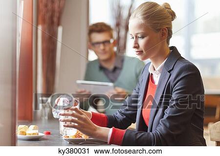 Businesswoman having lunch in a restaurant View Large Photo Image Stock Image - Businesswoman having lunch in a restaurant. Fotosearch