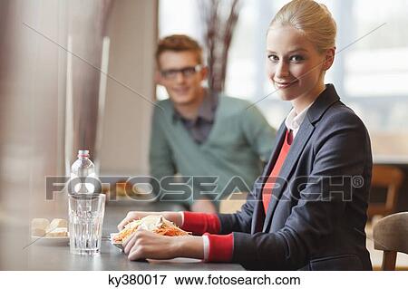 Stock Photo - Businesswoman having lunch in a restaurant. Fotosearch