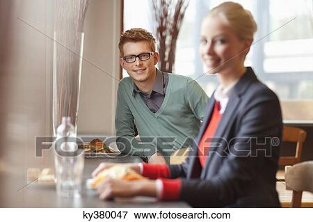 Stock Photo - Businesswoman having lunch in a restaurant. Fotosearch