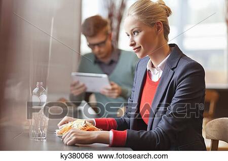 Businesswomen having lunch in a restaurant View Large Photo Image Stock Photo - Businesswomen having lunch in a restaurant. Fotosearch