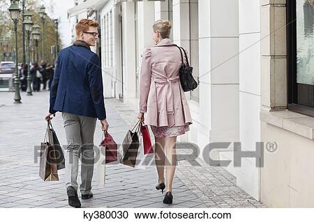 Couple carrying shopping bags View Large Photo Image Stock Image - Couple carrying shopping bags. Fotosearch