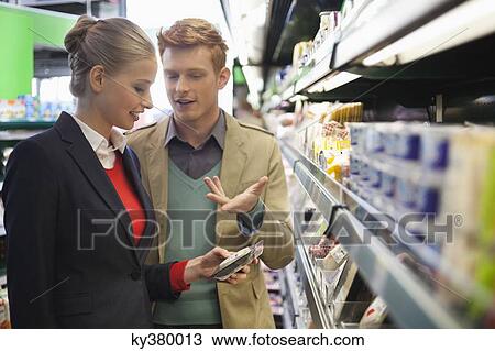 Couple shopping in a supermarket View Large Photo Image Stock Image - Couple shopping in a supermarket. Fotosearch