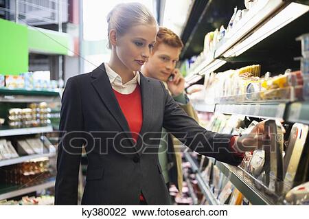 Couple shopping in a supermarket View Large Photo Image Stock Image - Couple shopping in a supermarket. Fotosearch