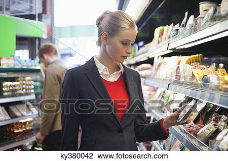 Couple shopping in a supermarket View Large Photo Image Stock Image - Couple shopping in a supermarket. Fotosearch
