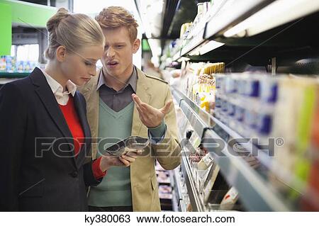 Couple shopping in a supermarket View Large Photo Image Stock Image - Couple shopping in a supermarket. Fotosearch