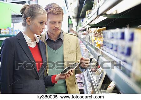 Couple shopping in a supermarket View Large Photo Image Stock Photography - Couple shopping in a supermarket. Fotosearch