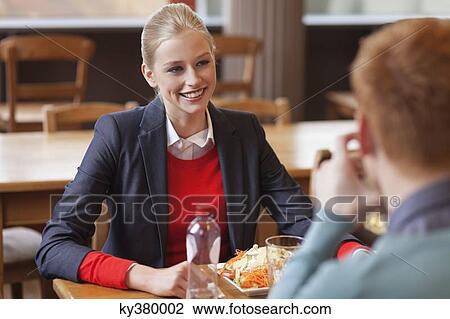 Couple sitting in a restaurant View Large Photo Image Stock Image - Couple sitting in a restaurant. Fotosearch