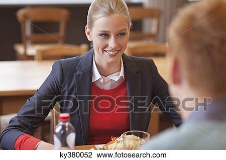 Couple sitting in a restaurant View Large Photo Image Stock Image - Couple sitting in a restaurant. Fotosearch
