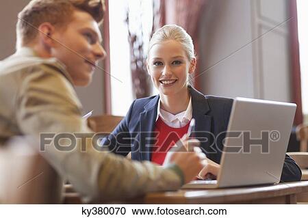 Couple sitting in a restaurant View Large Photo Image Stock Image - Couple sitting in a restaurant. Fotosearch