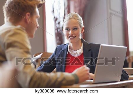 Couple sitting in a restaurant View Large Photo Image Stock Photo - Couple sitting in a restaurant. Fotosearch