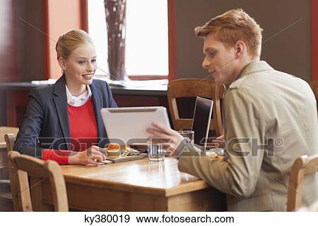 Couple sitting in a restaurant View Large Photo Image Stock Photo - Couple sitting in a restaurant. Fotosearch