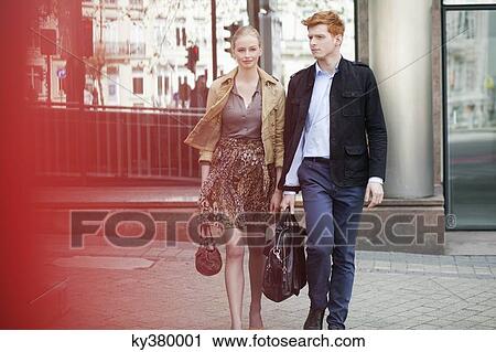 Stock Image - Couple walking on a footpath. Fotosearch