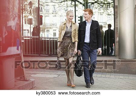 Stock Image - Couple walking on a footpath. Fotosearch
