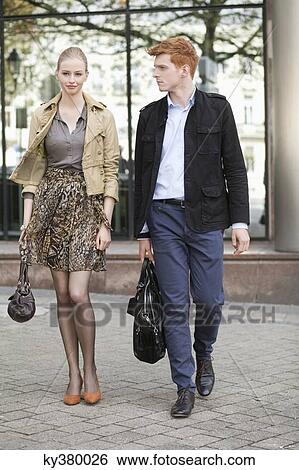 Couple walking on a footpath View Large Photo Image Stock Photograph - Couple walking on a footpath. Fotosearch