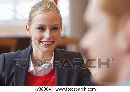 Happy businesswoman looking at her boyfriend in a restaurant View Large Photo Image Stock Image - Happy businesswoman looking at her boyfriend in a restaurant. Fotosearch