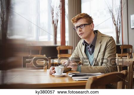 Man drinking tea in a restaurant View Large Photo Image Stock Photo - Man drinking tea in a restaurant. Fotosearch