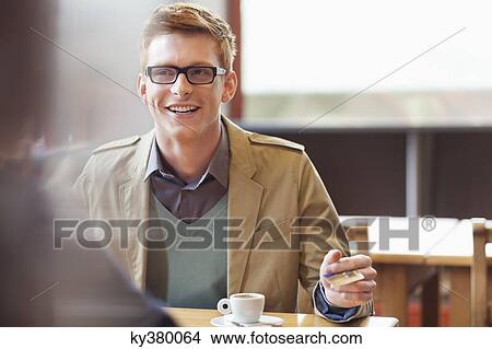 Man paying bill by credit card in a restaurant View Large Photo Image Picture - Man paying bill by credit card in a restaurant. Fotosearch