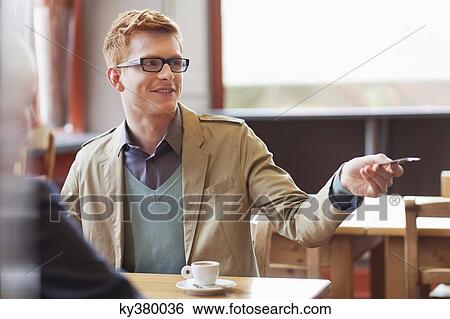 Stock Photograph - Man paying bill by credit card in a restaurant. Fotosearch