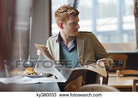Man sitting in a restaurant and reading a newspaper View Large Photo Image Stock Image - Man sitting in a restaurant and reading a newspaper. Fotosearch