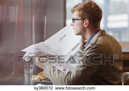 Man sitting in a restaurant and reading a newspaper View Large Photo Image Stock Image - Man sitting in a restaurant and reading a newspaper. Fotosearch