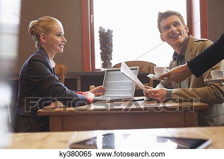 Waiter giving tea to a couple in a restaurant View Large Photo Image Stock Photography - Waiter giving tea to a couple in a restaurant. Fotosearch
