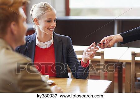 Woman paying bill by credit card in a restaurant View Large Photo Image Stock Photo - Woman paying bill by credit card in a restaurant. Fotosearch