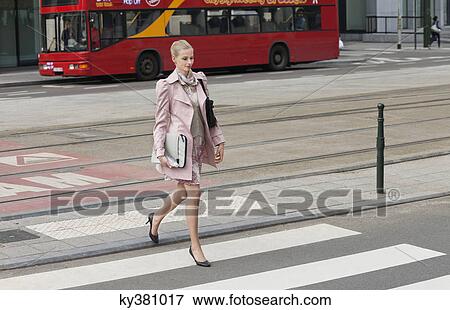 Businesswoman crossing the road View Large Photo Image Stock Photo - Businesswoman crossing the road. Fotosearch