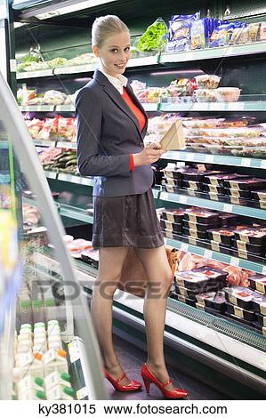 Woman shopping in a supermarket View Large Photo Image Stock Photography - Woman shopping in a supermarket. Fotosearch