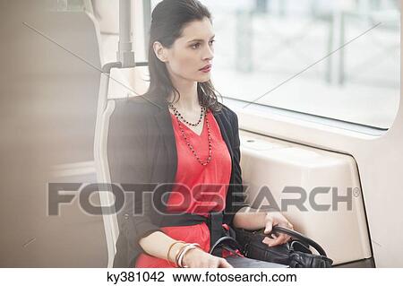 Stock Image - Woman traveling in a bus. Fotosearch