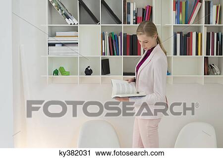 Businesswoman reading a book View Large Photo Image Stock Image - Businesswoman reading a book. Fotosearch