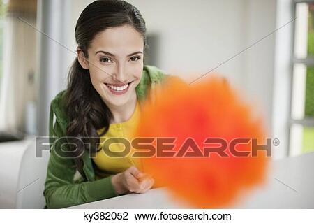 Happy woman holding a feather duster View Large Photo Image Stock Image - Happy woman holding a feather duster. Fotosearch