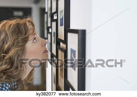 Interior designer looking at a painting View Large Photo Image Stock Photo - Interior designer looking at a painting. Fotosearch