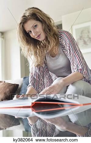 Portrait of a beautiful woman reading a book at home View Large Photo Image Picture - Portrait of a beautiful woman reading a book at home. Fotosearch