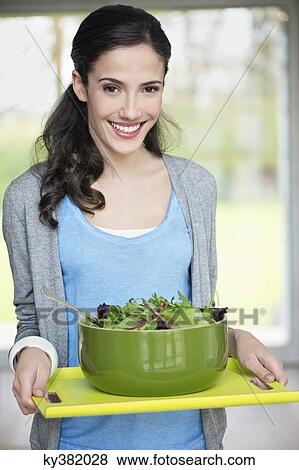 Woman carrying a bowl of salad on a tray View Large Photo Image Stock Photo - Woman carrying a bowl of salad on a tray. Fotosearch