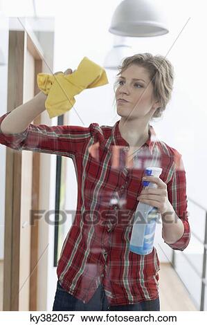 Woman cleaning a glass door View Large Photo Image Stock Photo - Woman cleaning a glass door. Fotosearch