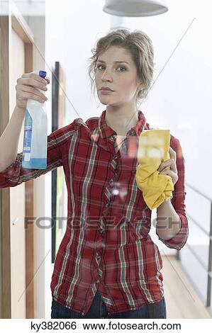 Woman cleaning glass door View Large Photo Image Stock Photograph - Woman cleaning glass door. Fotosearch