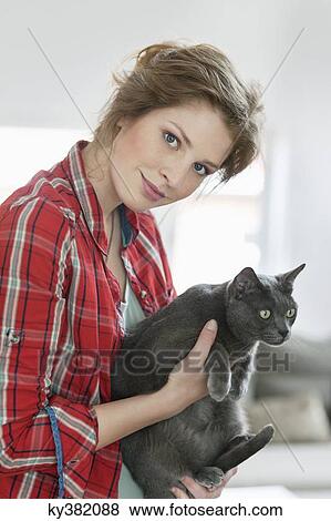 Woman holding a grey cat View Large Photo Image Stock Photo - Woman holding a grey cat. Fotosearch