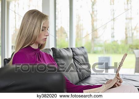 Woman reading a newspaper View Large Photo Image Stock Image - Woman reading a newspaper. Fotosearch