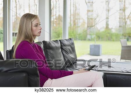 Woman watching television View Large Photo Image Stock Photography - Woman watching television. Fotosearch