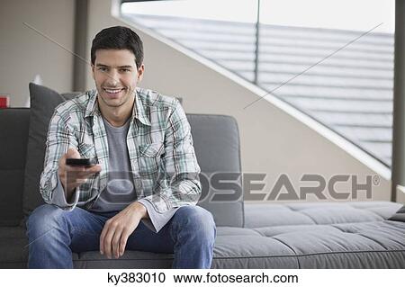 Man changing channels with a remote control View Large Photo Image Stock Image - Man changing channels with a remote control. Fotosearch