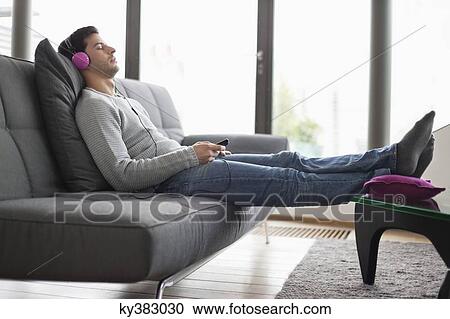 Man listening to music with an mp3 player View Large Photo Image Stock Image - Man listening to music with an mp3 player. Fotosearch