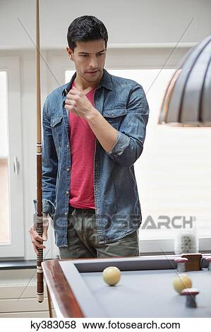 Man looking at a pool table View Large Photo Image Stock Photo - Man looking at a pool table. Fotosearch