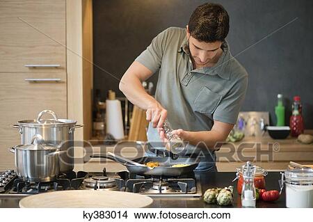 Man preparing food in the kitchen View Large Photo Image Picture - Man preparing food in the kitchen. Fotosearch