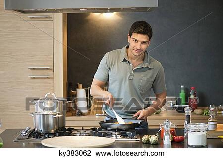 Man preparing food in the kitchen View Large Photo Image Stock Image - Man preparing food in the kitchen. Fotosearch